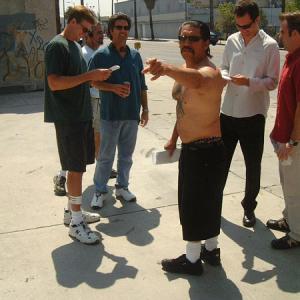 Left to right Directors Rob Muir and Bob Hilgenberg rehearse actors Danny Trejo Johnny Sneed and Christopher Moynihan on the set of Hiding in Walls