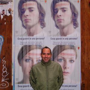 Franco Di Chiera in Rome in front of a poster for the gay anti-discrimination campaign: What do you see in a person? Watch his films and find out. Experience the full range of human emotion - the drama of life. Diversity is the key.