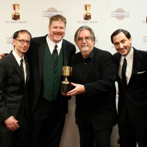 Presenter Seth Green congratulates the winners for best home entertainment production: David X. Cohen, John DiMaggio, Matt Groening, Patric Verrone, Lee Supercinski