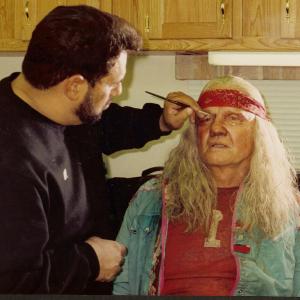Ken Diaz applying the sun baked, homeless, half breed Native American Shaman makeup, to Jon Voight who is playing the Blind Man in 