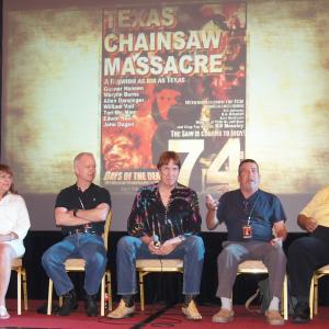 This photo was from the best reunion of The Texas Chain Saw Massacre (1974) at Days of the Dead in USA in 2012. From the left, the emcee Shawn Patrick, (Seated, L-R) ''Sally Hardesty'' Marilyn Burns, ''Pam''Teri McMinn, ''Kirk'' William Vail, ''Grandfather'' John Dugan, ''Hitchhiker'' Ed Neal, ''Cattle Truck Driver'' Ed Guinn, ''Jerry'' Allen Danziger from the TCM panel at Days of the Dead Indianapolis 2012.