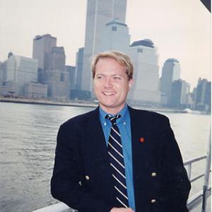 Jim Dykes with twin towers of World Trade Center in background