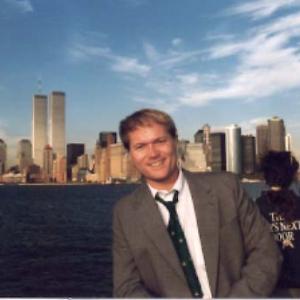 Jim Dykes on New York harbor with World Trade Center in distance
