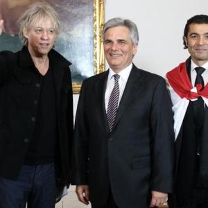 Irish musician and activist Bob Geldof Austrian Chancellor Werner Faymann and Egyptian actor Khaled Nabawy LR pose in the chancellery in Vienna March 3 2011 Geldof and Nabawy are in Vienna to visit the traditional opera ball later in the evening