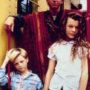 Promo Poster for 1988 film The Night Train to Kathmandu with Trevor Eyster Eddie Castrodad and Milla Jovovich from left to right