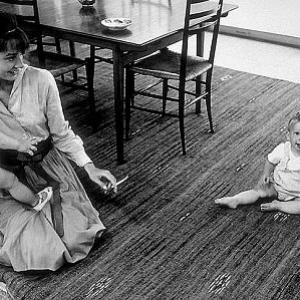 331130 Audrey Hepburn holds one year old son Sean Ferrer while Chris Willoughby poses for his father