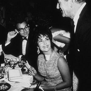 Elizabeth Taylor, John Wayne and Danny Thomas at a party thrown by Eddie Fisher at the Coconut Grove C. 1960