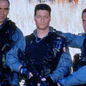 On the set of Delta Force Clear Target in South Africa actors LR Greg Collins Bryan Genesse and Jim Fitzpatrick pose for a Publicity Photo in 1998