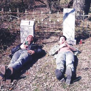 Sam Shepards Curse of the Starving Class actors Jim Fitzpatrick and Henry Thomas relaxing in their movie family graveyard in 1993