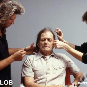 THE BLOB Makeup effects artist Mike Smithson (L) finalizes the prosthetic makeup while Makeup Effects Supervisor Tony Gardner (R) adds the lace hairpieces to actor Del Close as Reverend Meeker for the Chuck Russell helmed film 