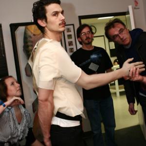 127 HOURS Preproduction Actor James Franco and Director Danny Boyle at Alterian Inc for the first fitting of the prototype arm harness with Specialty Costumer Ginger AnglinCervantez L and Makeup Effects Designer Tony Gardner center