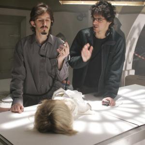 SEED OF CHUCKY: Behind the scenes: Writer / Director Don Mancini (R) sets up a shot where puppet supervisor and actor Tony Gardner (L) will begin to disassemble the Tiffany character in a scene from 