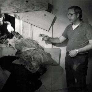 WriterDirector Dan OBannon rehearses the Half Corpses attack of actor Brian Peck with DesignerPuppeteer Tony Gardner as actor Miguel Nunez looks on