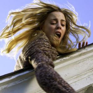 MELISSA GEORGE tries to save her daughter from falling off the roof in THE AMITYVILLE HORROR