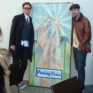 Rainn Wilson and Matthew Grant Godbey with a painting Matthew created for the Planting Peace charity in Haiti in 2009