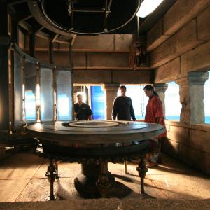 Ancient lighthouse with rotating array of mirrors. Built on stage with translight backing for 