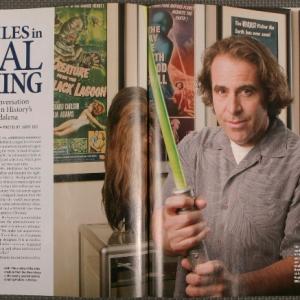 Auctioneer Joe Madelena holding the green painted cardboard light saber used in the original Star Wars movie, it later sold at auction for $240.000 (U.S.)