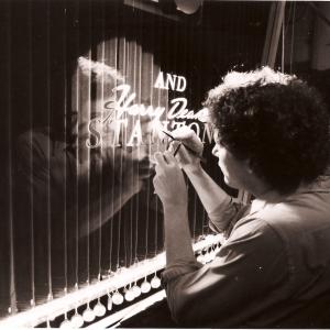 One From The Heart  Gary touches up title art on miniature curtain set
