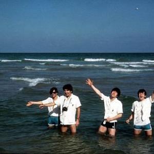 The Beatles Ringo Starr George Harrison John Lennon Paul McCartney playing in the water