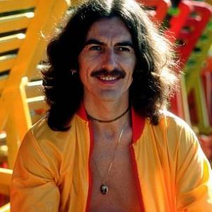 George Harrison in Acapulco posing near wooden lounge chairs January 1977