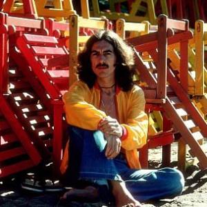 George Harrison posing with colorful wooden lounge chairs, January 1977