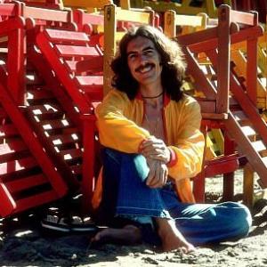George Harrison in Acapulco posing with colorful wooden lounge chairs, January 1977