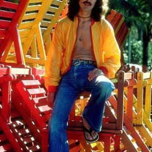 George Harrison in Acapulco posing with colorful wooden lounge chairs, January 1977