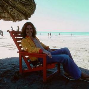 George Harrison in Acapulco enjoying the shade on the beach, January 1977