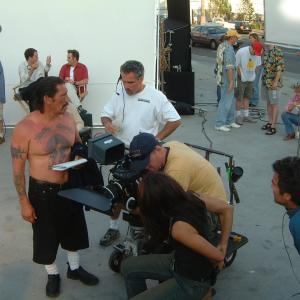 Director Bob Hilgenberg sets up a shot with actor Danny Trejo.