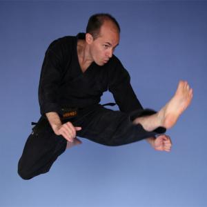 2nd Dan  Okinawa Kenpo Karate performing mae tobi geri jump front kick