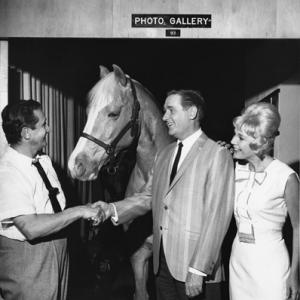 Mister Ed Alan Young shaking hands with photographer Gabi Rona as Connie Hines looks on circa 1963