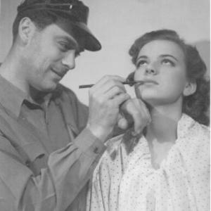 Louis Hippe applying makeup on Barbara Hippe his daughter at the studio