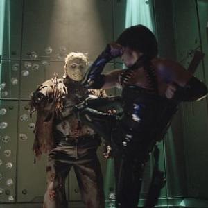 far right Lisa Ryder battles Kane Hodder as Jason Voorhees in New Line Cinemas JASON X