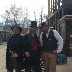 From left actors Anthony Hornus as Captain Ketner An Ordinary Killer Miracle at Sage Creek Dean Teaster as Digger Figure in the Forest An Ordinary Killer ER and Taymour Ghazi Deputy Wilson Tangy Guacamole on the set of Ghost Town filmed in M