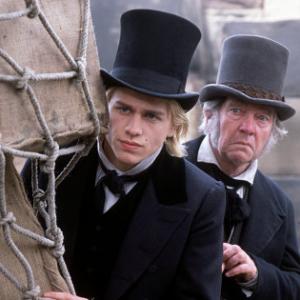 Nicholas Nickleby CHARLIE HUNNAM and Newman Noggs TOM COURTENAY keep an eye on mischief
