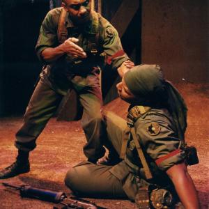 Photo from the award winning military play, Niggaz with Attitudes and Big Guns. Ty Granderson Jones (left) portrays crazed soldier, Master Sgt. Cobb. Ty recieved an ADA nod for Lead Actor in a Play - Drama. Layon Gray (down right).