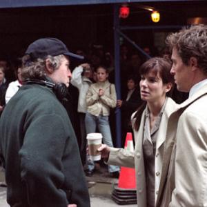 Director Marc Lawrence on the set with Sandra Bullock and Hugh Grant