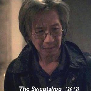Geoff as Ahong, sweatshop owner, in 