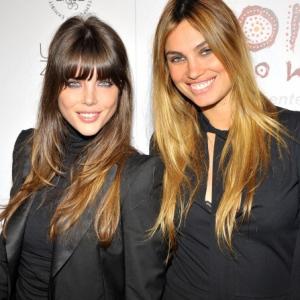 Models Nicole Lenz (L) and Alina Puscau arrive at the Donna Karan and Russel James' Nomad Two Worlds Opening Gala at Pier 59 Studios on February 22, 2011 in Santa Monica, California.