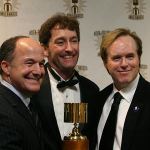 Best Feature winners Brad Lewis and Brad Bird surround presenter and event host Tom Kenny