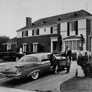 ART LINKLETTER WITH HIS WIFE LOIS AT THEIR HOME ON MAPLETON BRIVE IN HOLMBY HILLS CA WITH DODGE CIRCA 1957