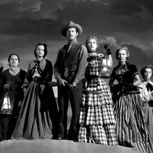 Still of Robert Taylor, Julie Bishop, Denise Darcel, Beverly Dennis, Hope Emerson, Marilyn Erskine and Lenore Lonergan in Westward the Women (1951)