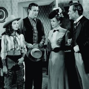 Still of John Wayne Ward Bond Audrey Long and Ella Raines in Tall in the Saddle 1944