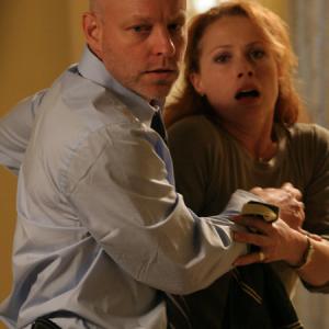 Detective Paul Grunning (James Macdonald) protects his wife (Scarlett McAlister).