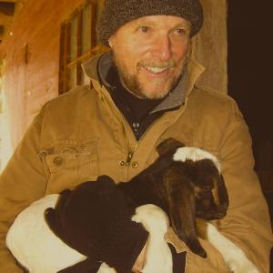 While visiting a farm on chilly day - this baby goat was shivering. William cuddled the goat until it stopped shivering and feel asleep in his arms.
