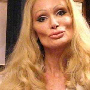 DeLane as Jacey Goldberg on the last episode of season one--CASTLE. Jacey is a plastic surgery addict, and DeLane is wearing temporary false lips, breasts, hair, eye lashes, and eye brows for the role.