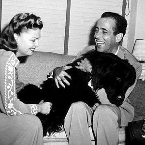 Humphrey Bogart and his third wife Mayo Methot with their black Newfoundland dog Cappy at home circa 1944