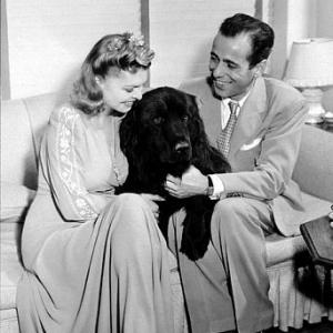 Humphrey Bogart and his third wife Mayo Methot with their black Newfoundland dog Cappy at home circa 1944