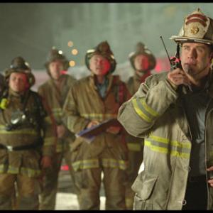 Captain Mike Kennedy (John Travolta, right) mobilizes his team to rescue their trapped comrade.