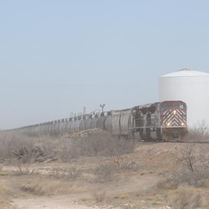 2013. Texas - New Mexico Railroad. A 79-car crude oil unit train moves south near Hobbs, NM, heading for the UP interchange at Monahans, Texas. Yes, that's blowing dirt enshrouding the train.